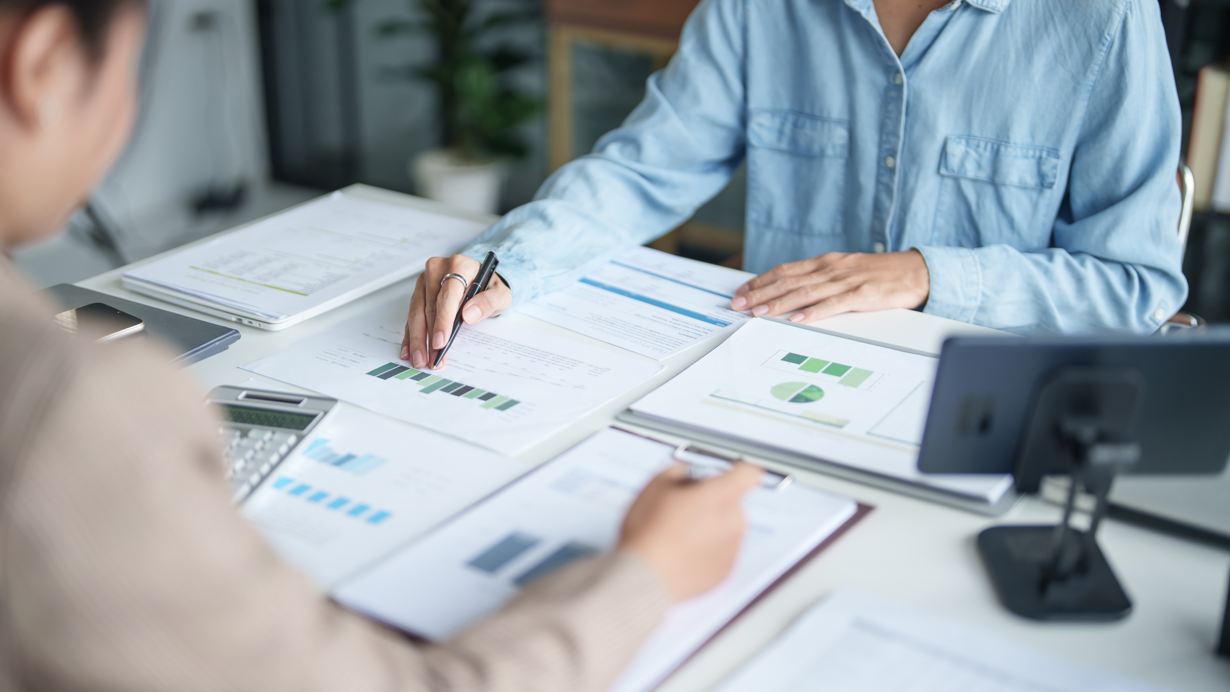 People with papers on a desk